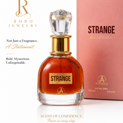 Strange Eau De Parfum by Alonzo 100ml displayed in an elegant luxury glass bottle with a crystal-inspired cap beside its blush pink packaging.